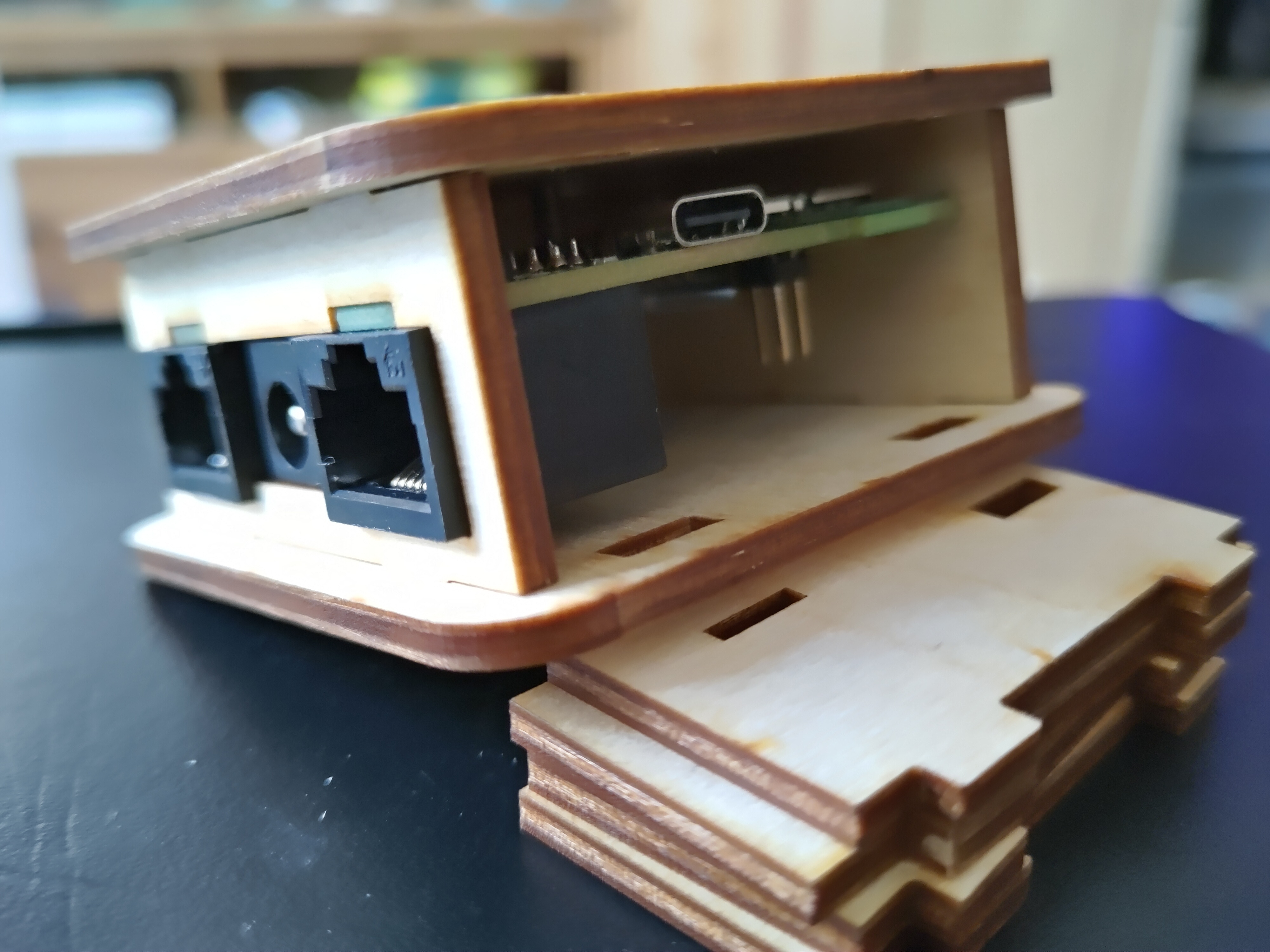 A partially assembled laser cut case, with a PCB mounted inside it