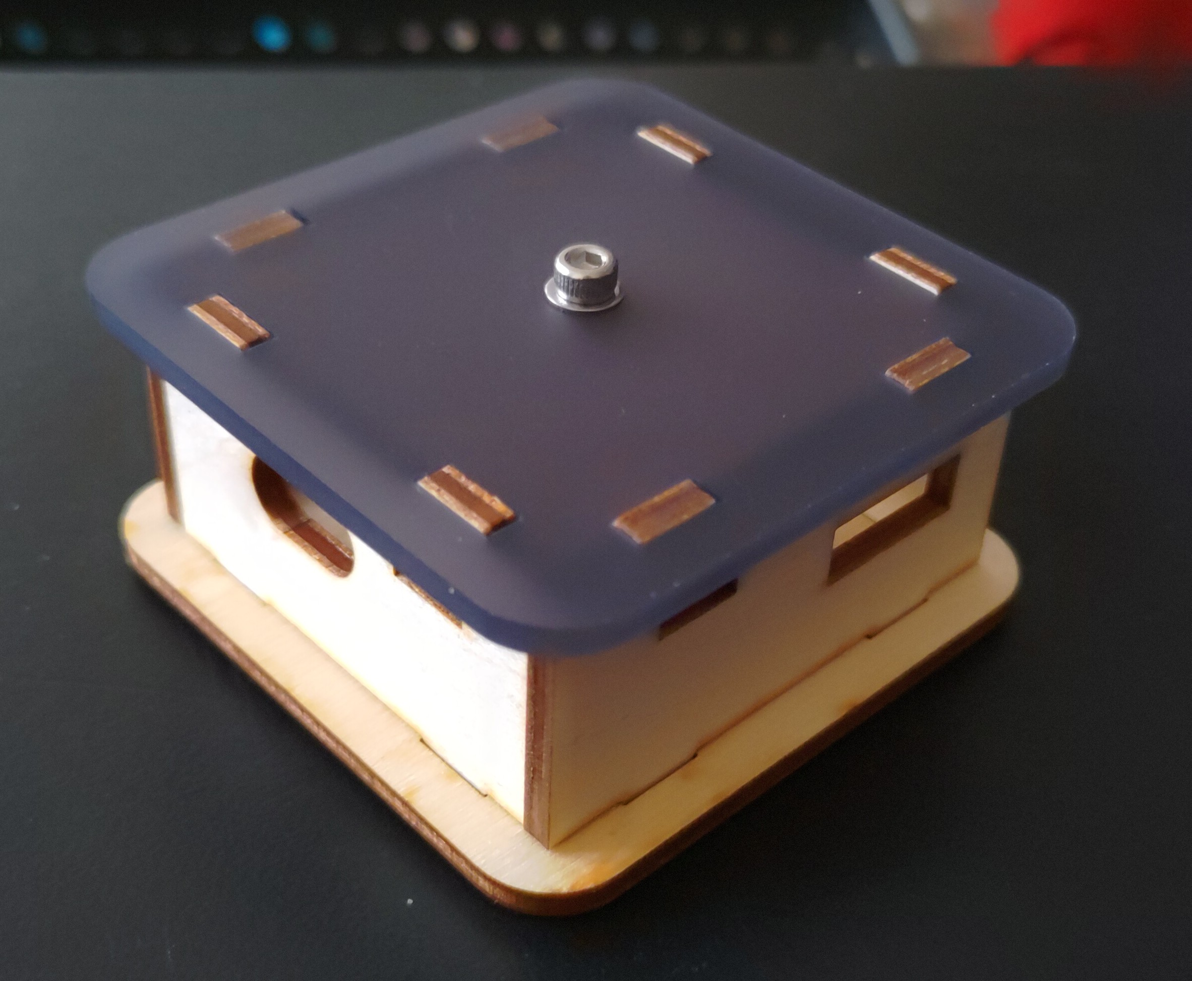 The same laser cut case as previously shown, but with a dark acrylic lid, rather than a wooden lid