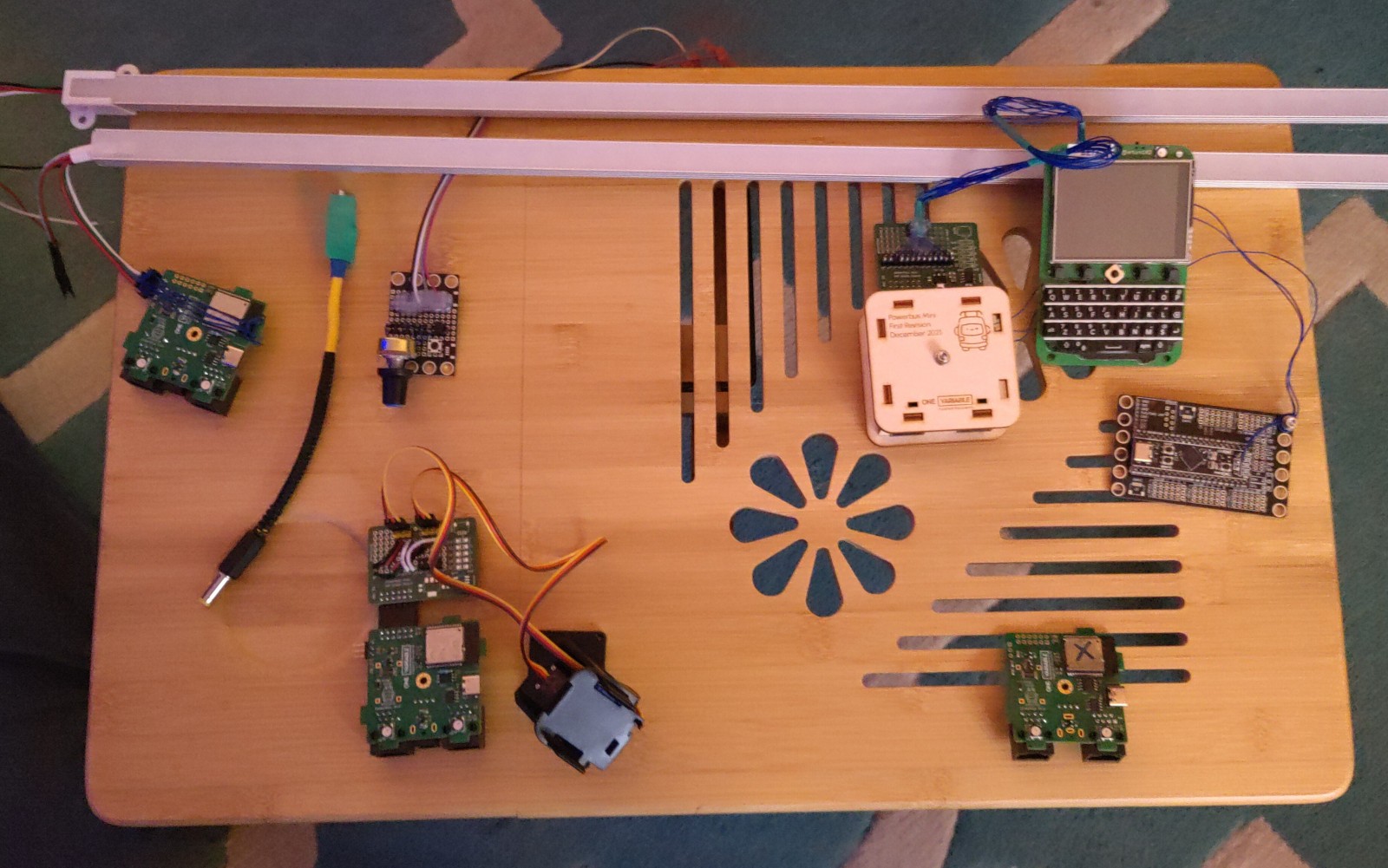 A table containing four powerbus-mini circuit boards, and their assorted accessories