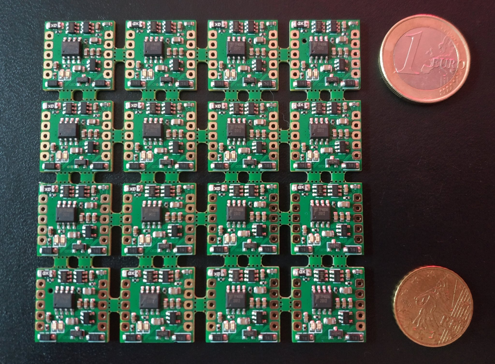 A panel of 16 circuit boards. Each is slightly smaller than a 1 Euro coin